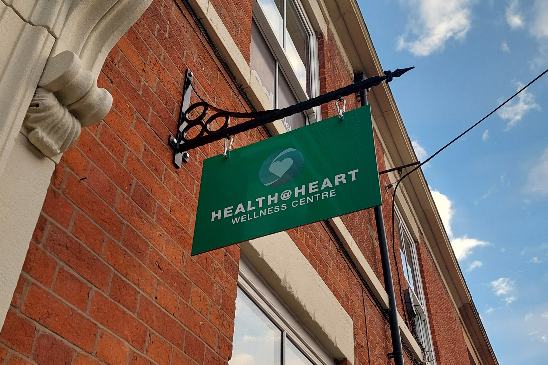 Health@Heart swing sign on the side of a building